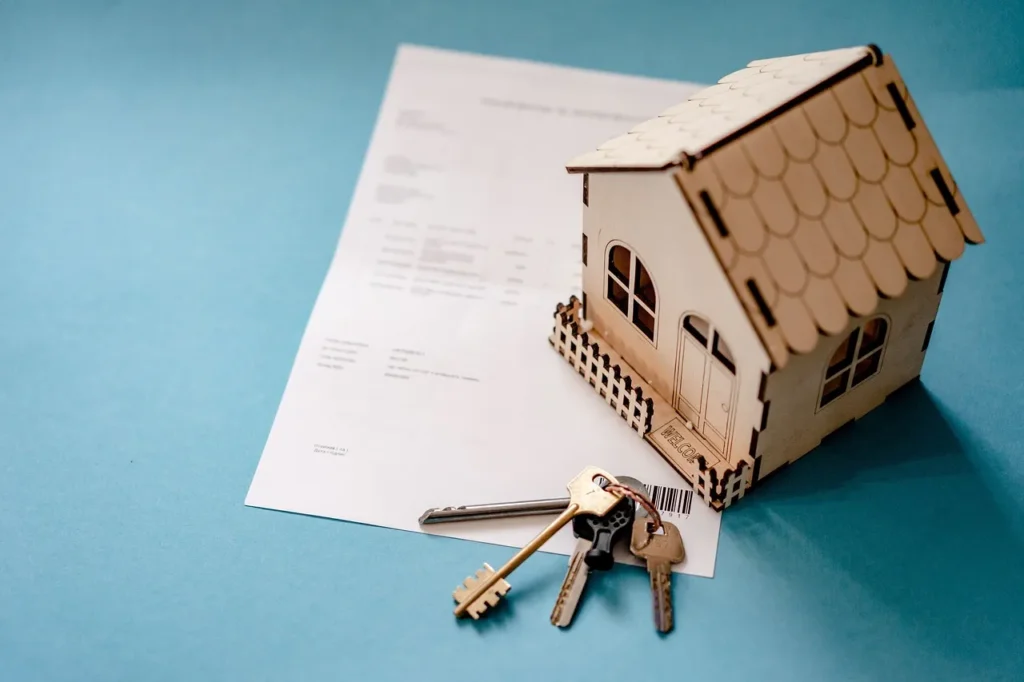 Model house with keys on a contract.