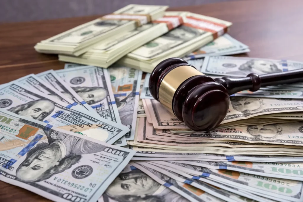 A pile of money with a gavel on it.